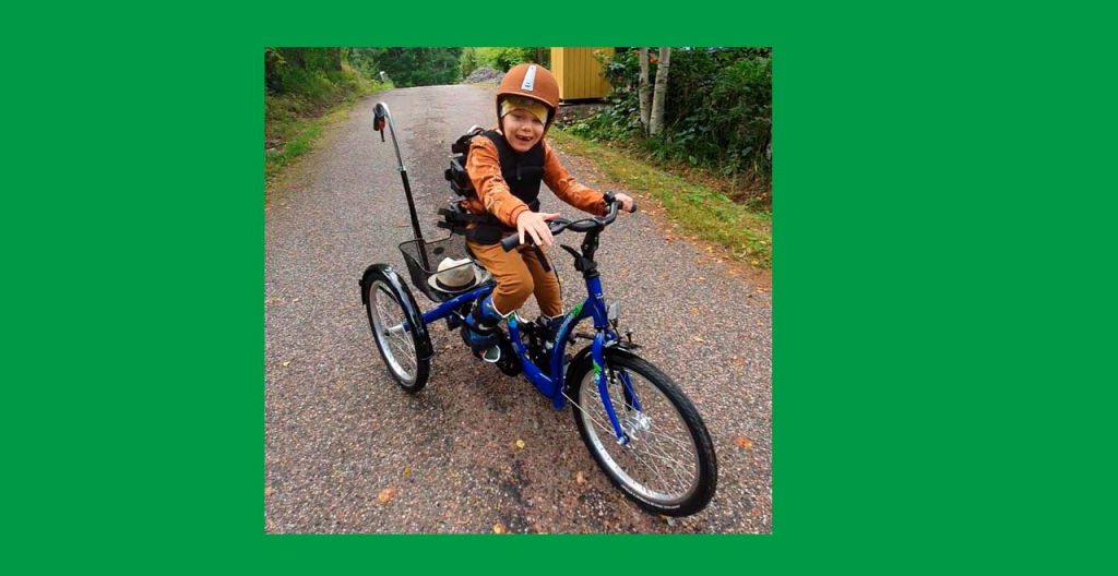 Pyöräily kolmepyöräisellä erityispyörällä auttaa pitämään yllä Kasper Artelin jalkojen toimintakykyä ja liikkuvuutta. Kuva: Jenni Arteli